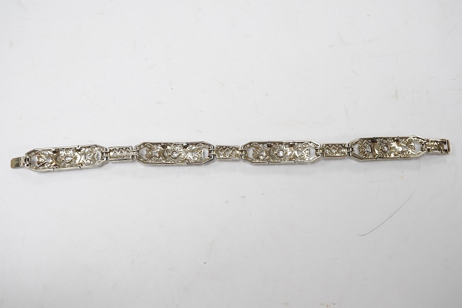 An early 20th century pierced white gold and millegrain set diamond cluster bracelet, set with round and rose cut stones, 18.1cm, gross weight 18.1 grams. Condition - fair to good